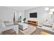 Bright living room offers wood floors, neutral paint, TV, and comfortable seating at 4 Galaxy Ct, Durham, NC 27705