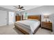 Spacious main bedroom with a wooden bed frame, dresser, soft carpet, and a bright window at 4 Galaxy Ct, Durham, NC 27705