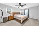 Comfortable primary bedroom with ceiling fan, carpet flooring, and natural light at 4 Galaxy Ct, Durham, NC 27705