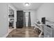 Office area with modern white desk and cabinets, natural light, and a view of the kitchen at 4 Galaxy Ct, Durham, NC 27705