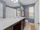 Bathroom boasts a long vanity with a large mirror, and a shower-tub combo for relaxation at 4014 White Kestrel Dr, Raleigh, NC 27616