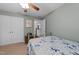 Bedroom with a floral bedspread, ceiling fan, and ample closet space for comfortable living at 4014 White Kestrel Dr, Raleigh, NC 27616