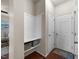 Functional entryway with coat hooks, a built-in bench, and storage baskets for organization at 4014 White Kestrel Dr, Raleigh, NC 27616