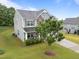 Two-story home featuring a stone facade, well-manicured lawn and mature trees for beauty at 4014 White Kestrel Dr, Raleigh, NC 27616