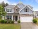 Beautiful two-story home featuring stone accents, a two-car garage, and a well-manicured lawn at 4014 White Kestrel Dr, Raleigh, NC 27616