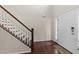 Bright foyer featuring hardwood floors, white walls, and staircase with wood railing at 4014 White Kestrel Dr, Raleigh, NC 27616