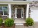 Charming front entry features stone accents, side-light windows, and a dark-colored door with security features at 4014 White Kestrel Dr, Raleigh, NC 27616