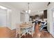 Bright eat-in kitchen featuring modern dark cabinets, stainless steel appliances and wood flooring at 4014 White Kestrel Dr, Raleigh, NC 27616