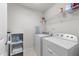 Laundry room featuring a washer, dryer, storage shelves and an ironing board for convenience at 4014 White Kestrel Dr, Raleigh, NC 27616