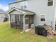 Cozy screened porch on back of home with outdoor seating, covered grill, and concrete patio at 4014 White Kestrel Dr, Raleigh, NC 27616