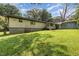 Spacious backyard featuring a well-maintained lawn and mature trees, perfect for outdoor activities and relaxation at 5840 Fayetteville Rd, Raleigh, NC 27603