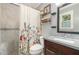 Stylish bathroom with granite countertop vanity, patterned shower curtain, and marble tile walk-in shower at 5840 Fayetteville Rd, Raleigh, NC 27603