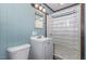 Charming bathroom with wood paneling, shower, mirror and single sink vanity at 5840 Fayetteville Rd, Raleigh, NC 27603