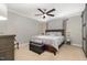 Comfortable bedroom with neutral tones, ceiling fan, plush bed, and barn door at 5840 Fayetteville Rd, Raleigh, NC 27603
