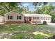 Charming one-story home with a brick accent, a manicured lawn, and mature trees at 5840 Fayetteville Rd, Raleigh, NC 27603