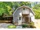 Charming cottage-style home featuring a small porch, wood deck, and lush landscaping at 5840 Fayetteville Rd, Raleigh, NC 27603