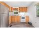 Traditional kitchen with stainless steel refrigerator and modern white electric range at 5840 Fayetteville Rd, Raleigh, NC 27603