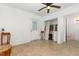 Bright living room showcasing a ceiling fan, closet with water heater, and doorway to the bathroom at 5840 Fayetteville Rd, Raleigh, NC 27603