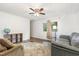 Comfortable living room with a couch, armchair, ceiling fan and wood-look flooring at 5840 Fayetteville Rd, Raleigh, NC 27603