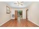 Bright living room with wood-look flooring, ceiling fan, and sliding glass doors to backyard at 5840 Fayetteville Rd, Raleigh, NC 27603
