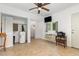 Open living room includes a ceiling fan, closet, air conditioner, tv, and doorway to the bathroom at 5840 Fayetteville Rd, Raleigh, NC 27603
