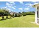 A large backyard featuring healthy green grass, landscaping, and fencing for privacy at 812 Teal Lake Dr, Holly Springs, NC 27540