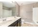 Bathroom features dual sinks, a large mirror, and a shower-tub combination at 812 Teal Lake Dr, Holly Springs, NC 27540