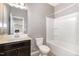 This bathroom offers essential amenities in a compact space, featuring a vanity, toilet, and shower-tub combination at 812 Teal Lake Dr, Holly Springs, NC 27540
