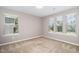 Well-lit bedroom featuring three bright windows and neutral walls, offering a serene and versatile living space at 812 Teal Lake Dr, Holly Springs, NC 27540