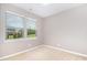 Bright bedroom with neutral walls, carpet, and two large windows that let in plenty of natural light at 812 Teal Lake Dr, Holly Springs, NC 27540