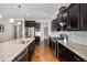 Features in this kitchen include stainless steel appliances, granite countertops, and dark cabinetry at 812 Teal Lake Dr, Holly Springs, NC 27540