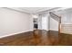 Open-concept living room featuring dark hardwood floors and staircase at 812 Teal Lake Dr, Holly Springs, NC 27540