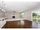 Open-concept living room with fireplace, ceiling fan, and sliding glass doors to the deck at 812 Teal Lake Dr, Holly Springs, NC 27540