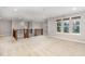 Spacious loft area with neutral walls, carpeted floor, and bright windows offering natural light and neighborhood views at 812 Teal Lake Dr, Holly Springs, NC 27540