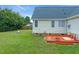 Charming backyard with a red deck, small table, and a fire pit in the lawn at 104 Roscommon Ln, Clayton, NC 27520