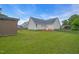 Spacious fenced backyard featuring green grass, a shed, and a small red deck at 104 Roscommon Ln, Clayton, NC 27520