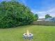 Private backyard featuring a fire pit with mature trees at 104 Roscommon Ln, Clayton, NC 27520