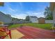 Backyard deck featuring a yellow rug, a fire pit, and green grass at 104 Roscommon Ln, Clayton, NC 27520