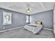 Comfortable bedroom with tray ceiling, carpet, and ample natural light from two windows at 104 Roscommon Ln, Clayton, NC 27520