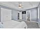 Spacious bedroom with carpet, a ceiling fan, ample closet space, and an attached bathroom at 104 Roscommon Ln, Clayton, NC 27520