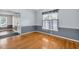 Bright dining room with hardwood floors, wainscoting, and natural light from the window at 104 Roscommon Ln, Clayton, NC 27520