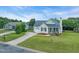 A well-maintained, one story home features a long driveway and an attached garage at 104 Roscommon Ln, Clayton, NC 27520