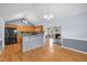 Open kitchen with wood cabinets, granite countertops, and seamless flow into the living area at 104 Roscommon Ln, Clayton, NC 27520