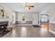 Bright living room featuring a fireplace, wood floors, and a doorway to the rest of the house at 104 Roscommon Ln, Clayton, NC 27520