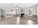 Spacious living room with fireplace, hardwood floors, neutral color scheme, and plenty of natural light at 104 Roscommon Ln, Clayton, NC 27520