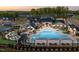 Community clubhouse with a large pool, lounge chairs, and green space perfect for entertaining at 194 Aspen Ave, Pittsboro, NC 27312