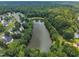 Aerial view of the community pond and neighborhood at 2003 Zbonack Ct, Creedmoor, NC 27522