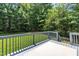 Spacious outdoor deck surrounded by lush trees and greenery with a grassy area for outdoor enjoyment at 2003 Zbonack Ct, Creedmoor, NC 27522