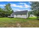This backyard features a lawn, mature trees and a deck at 2003 Zbonack Ct, Creedmoor, NC 27522