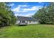 A well-maintained home with a spacious backyard, green lawn, and a deck perfect for outdoor activities at 2003 Zbonack Ct, Creedmoor, NC 27522
